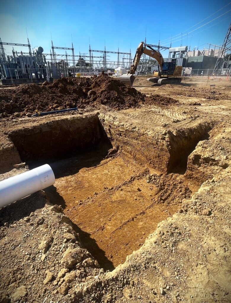 Geotechnician testing the base of an excavation for bearing capacity